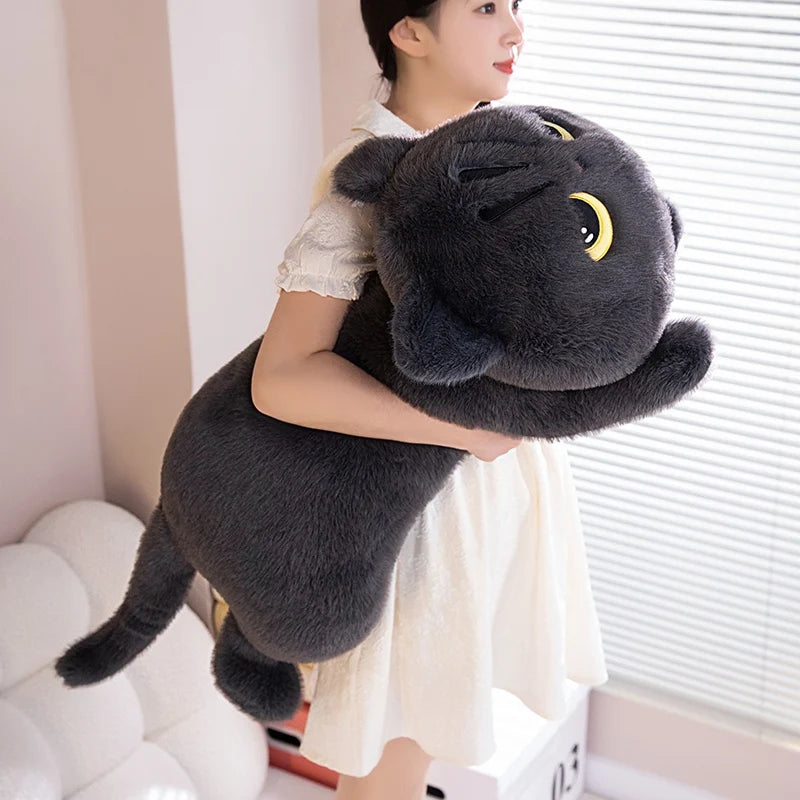 A cute soft pillow in the shape of a black cat