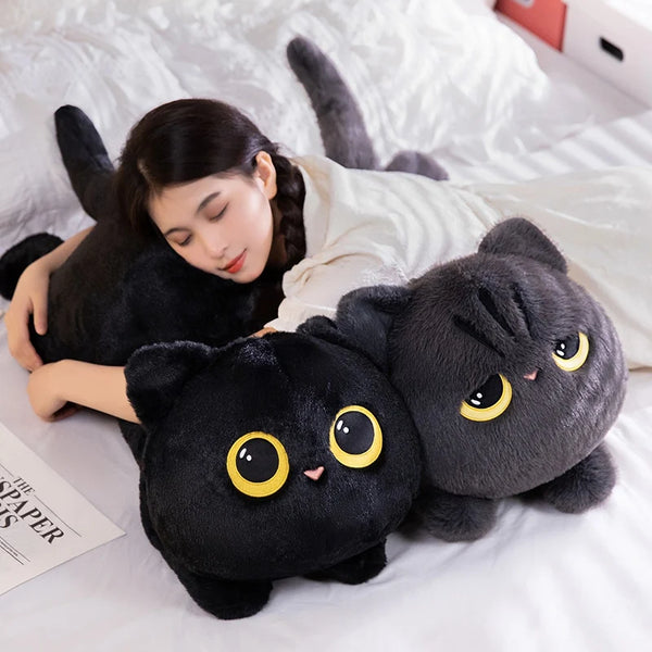 A cute soft pillow in the shape of a black cat