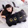 A cute soft pillow in the shape of a black cat